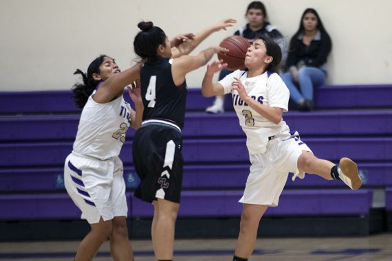 Lemoore's Maricella Perez, 3, and Kyla Wiley in action Tuesday night in the LHS Event Center. The Tigers crushed Mt. Whitney 58-19.